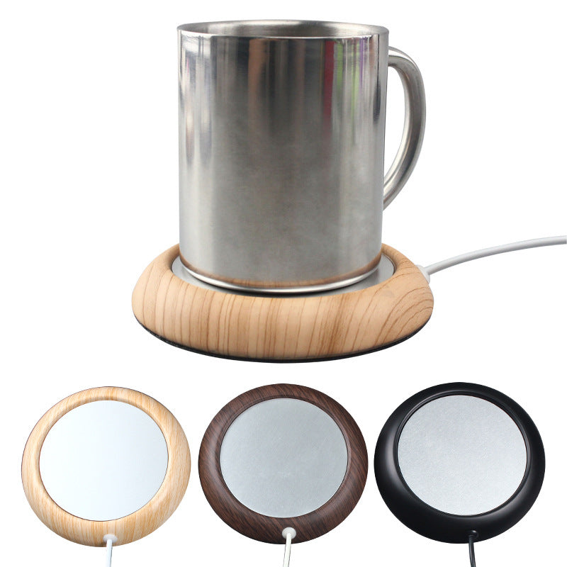 Koppvarmer med trekant og kaffekopp på pult