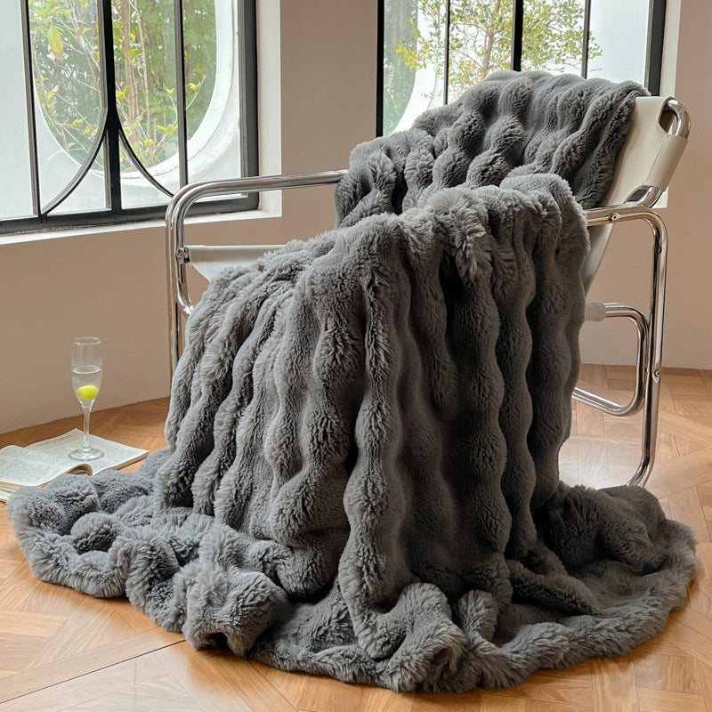 Mykt pledd med elegant bølgestruktur til sofa og seng
