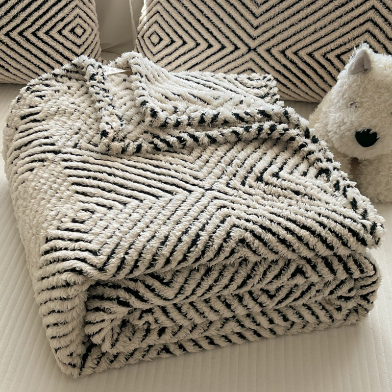 Myk pledd med geometrisk mønster til sofa og seng
