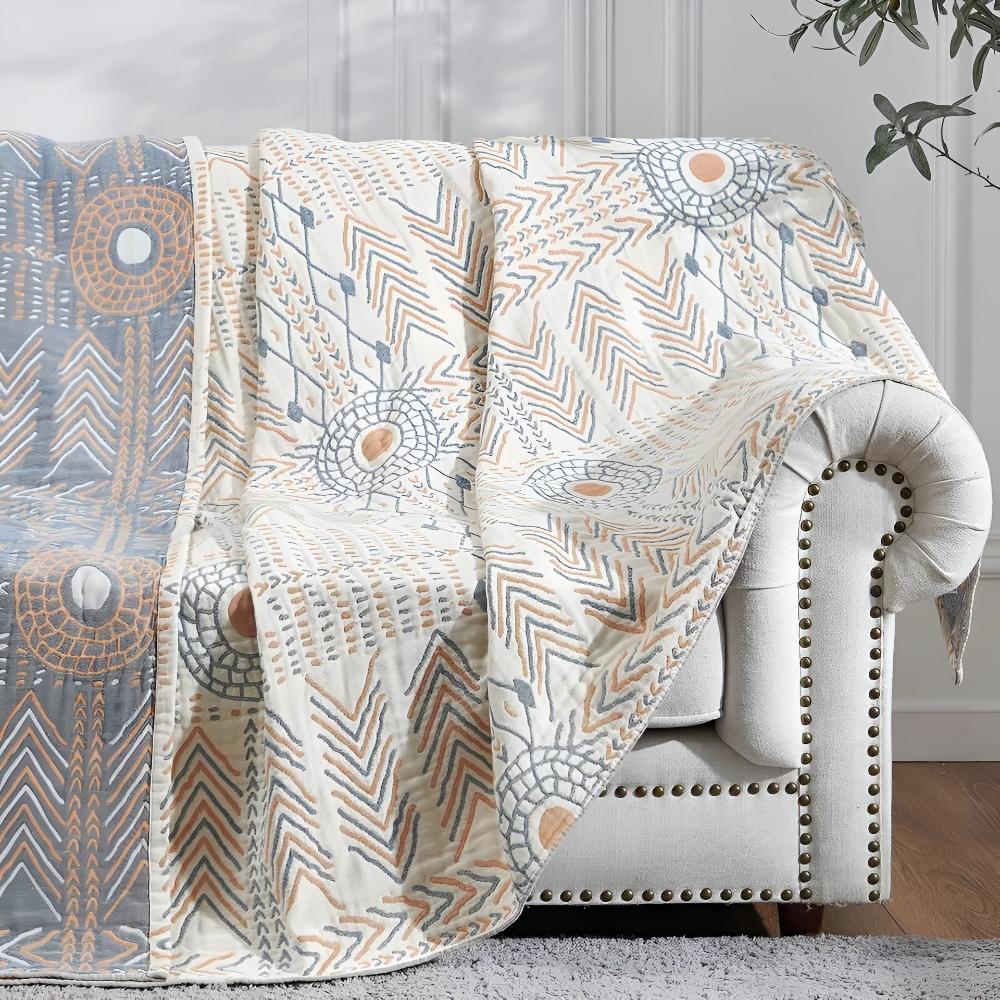Vendbart plysjpledd til sofa og seng med to uttrykk