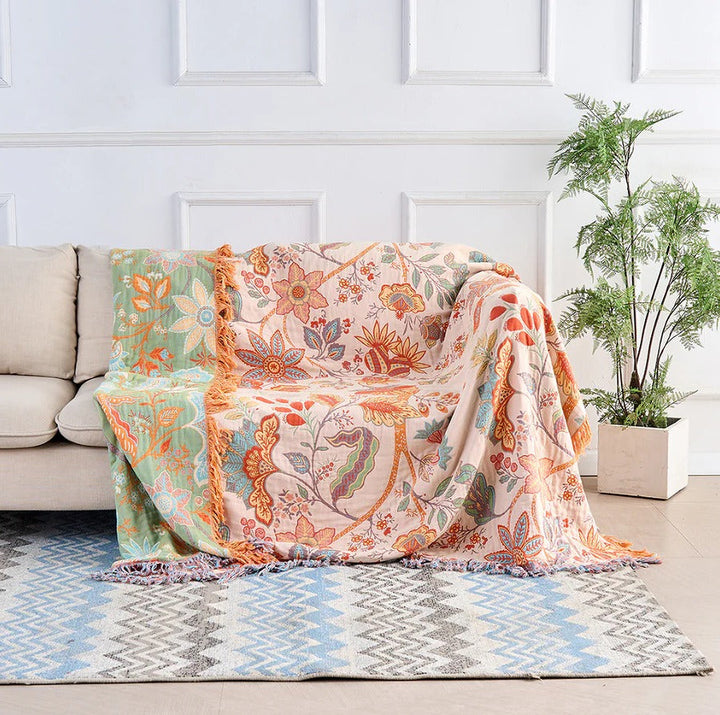Blomstrete pledd i bomull med boho-frynser og god pustevne