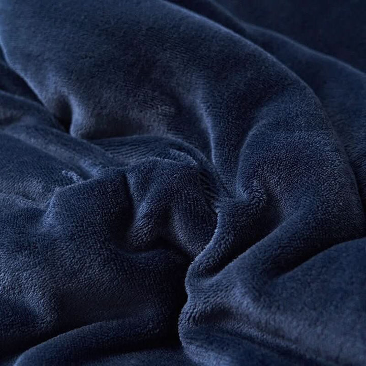 Vendbart sherpateppe i fleece til seng og sofa